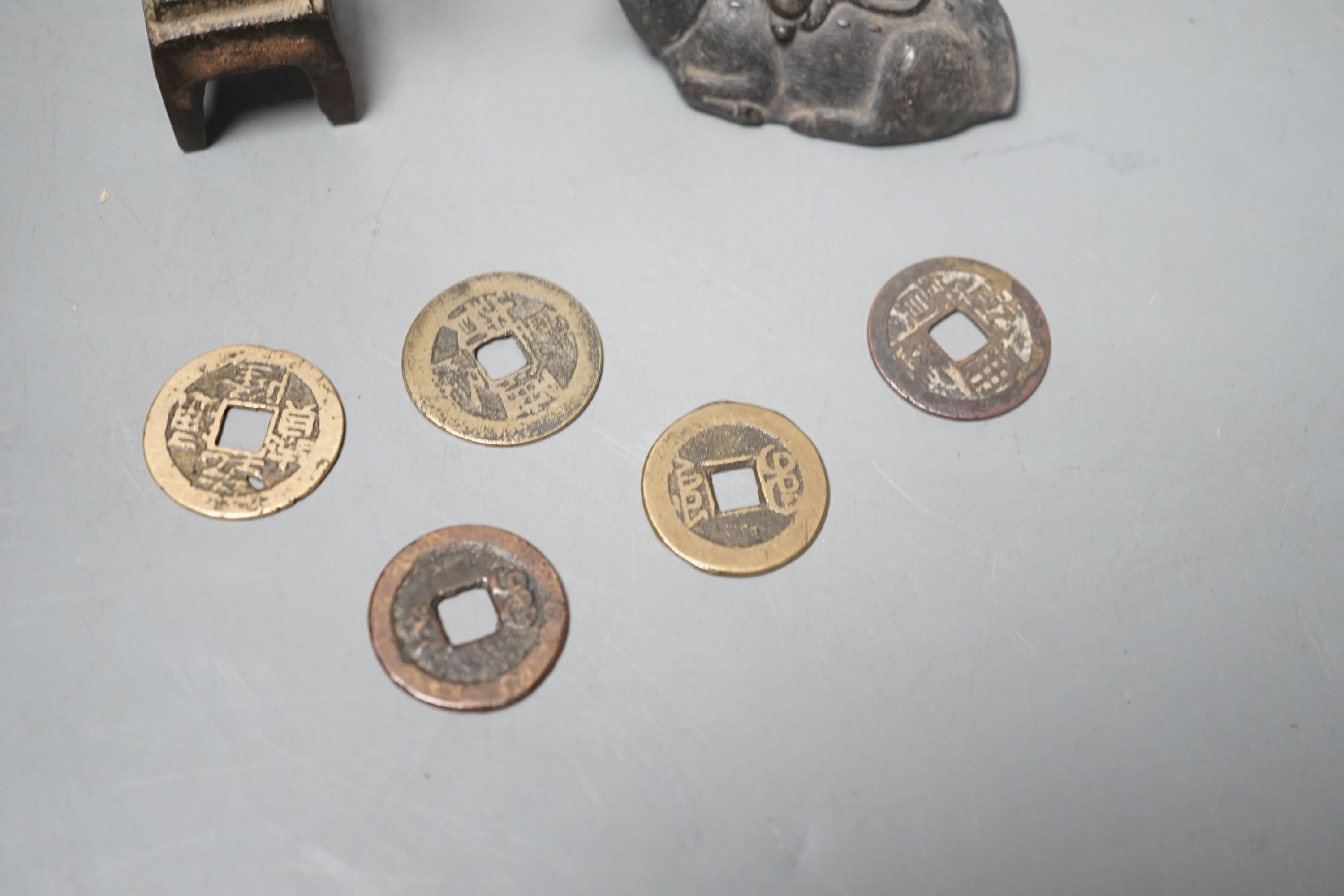 A collection of Chinese coins, together with a water dipper in the form is a seated animal, and a seated Buddha (7)